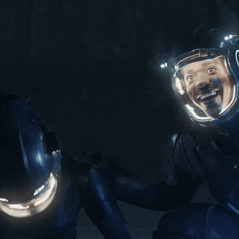 A Couple Of Astronauts Are Looking At Each Other With The Words Look In Yellow GIF