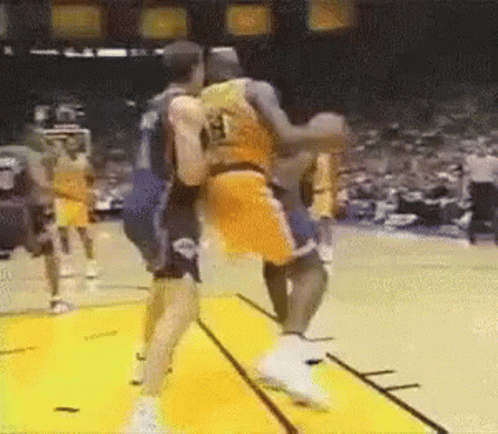 A Couple Of Basketball Players Are Fighting On A Court . GIF