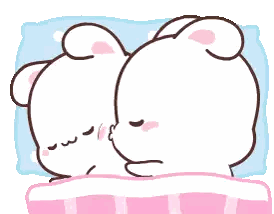 a couple of bears are sleeping on a bed and one bear is kissing the other on the cheek .