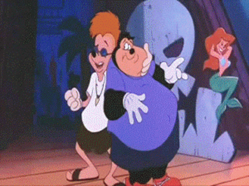 A Couple Of Cartoon Characters Are Standing Next To Each Other On A Stage . GIF
