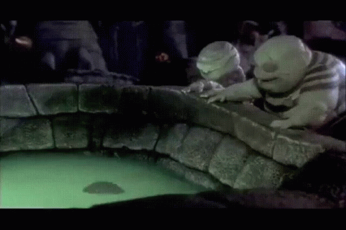 A Couple Of Cartoon Characters Looking At A Glowing Object In The Water GIF