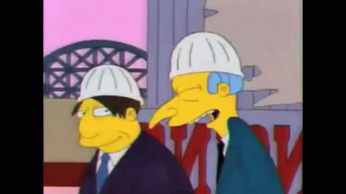 A Couple Of Cartoon Characters Wearing Hard Hats Standing Next To Each Other GIF