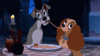 A Couple Of Cartoon Dogs Are Eating Spaghetti At A Table GIF