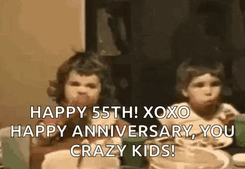 A Couple Of Children Are Sitting At A Table Eating Food And Talking . GIF