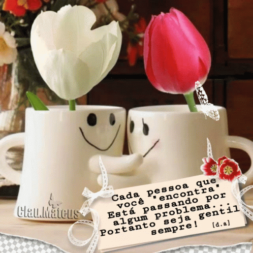 A Couple Of Cups With Smiley Faces On Them And Flowers In Them GIF