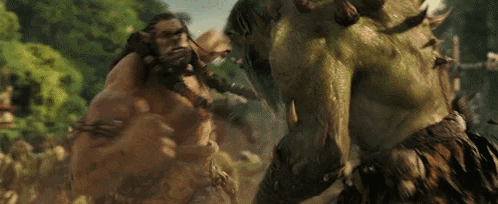 A Couple Of Giant Monsters Are Fighting Each Other In A Forest . GIF