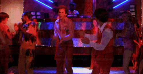 A Couple Of Men Are Dancing Together In A Disco Club . GIF