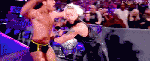 a couple of men are fighting in a wrestling ring .