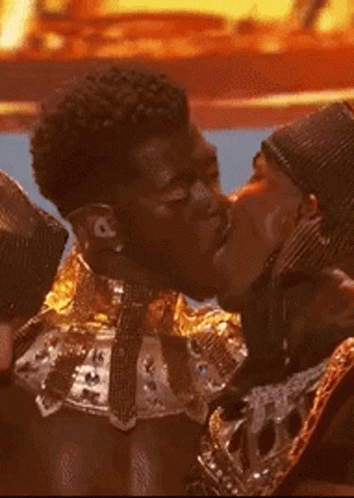 A Couple Of Men Are Kissing Each Other On The Cheek GIF