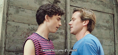 A Couple Of Men Are Standing Next To Each Other And Talking . GIF