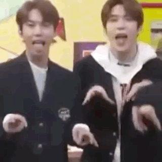 A Couple Of Men Are Standing Next To Each Other Making Funny Faces . GIF