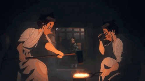 A Couple Of Men Are Working On A Piece Of Metal In A Dark Room GIF