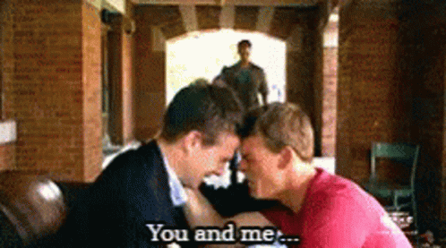 A Couple Of Men Kissing With The Words You And Me Behind Them GIF