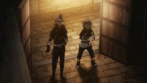 A Couple Of Men Standing In A Dark Room GIF