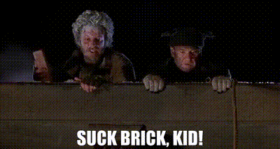 A Couple Of Men Standing Next To Each Other With The Words Suck Brick Kid Written On The Bottom . GIF