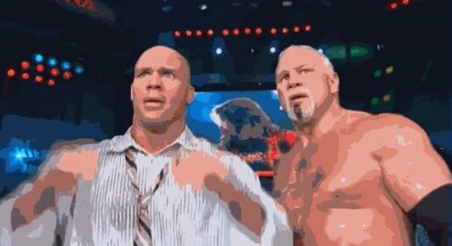 A Couple Of Men Standing Next To Each Other With Their Shirts Off GIF