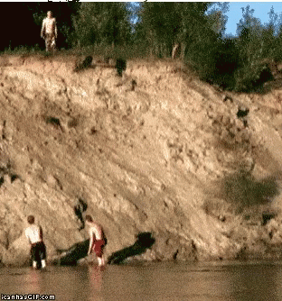 A Couple Of Men Standing On A Cliff Overlooking A Body Of Water With Icanh2gif.com Written Below Them GIF