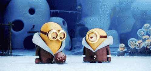 A Couple Of Minions Standing Next To Each Other With One Wearing Goggles And A Football GIF