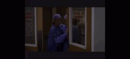 a couple of nurses are standing next to each other in a room .