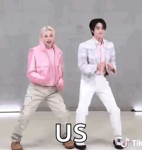 A Couple Of People Are Dancing Together And One Of Them Is Wearing A Pink Jacket And A White Shirt . GIF