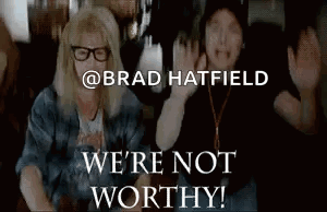 A Couple Of People Sitting Next To Each Other With The Words We 'Re Not Worthy Written On The Bottom . GIF