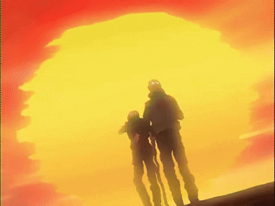 A Couple Of People Standing In Front Of A Large Yellow And Red Sun GIF