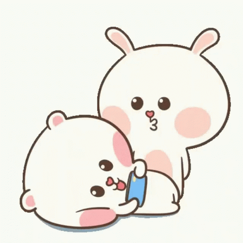A Couple Of Rabbits Are Sitting Next To Each Other And Hugging Each Other . GIF