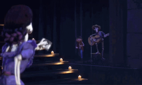 A Couple Of Skeletons Standing Next To Each Other With One Wearing A White Sombrero GIF