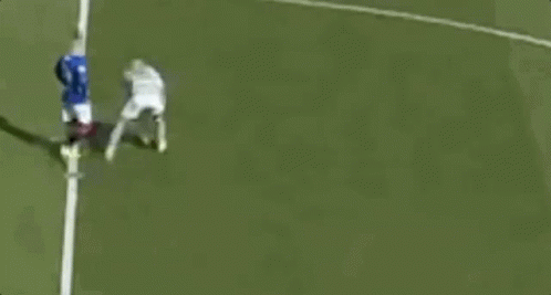 A Couple Of Soccer Players Are Standing On A Field Talking To Each Other . GIF