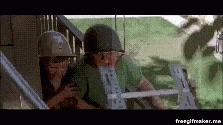 A Couple Of Soldiers Standing Next To Each Other On A Staircase . GIF