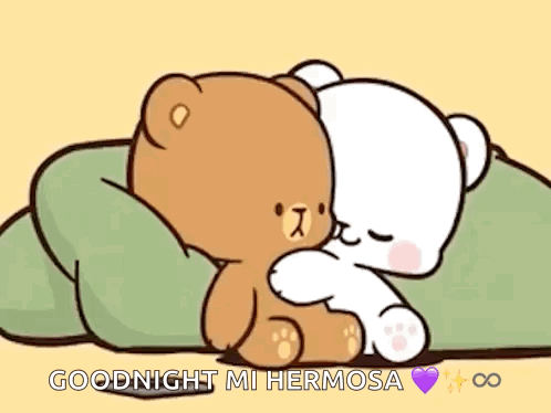 A Couple Of Teddy Bears Are Hugging Each Other On A Bed . GIF