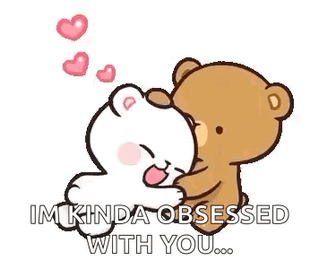 A Couple Of Teddy Bears Are Sitting Next To Each Other . GIF