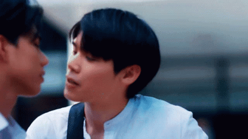 Two Young Men Standing Next To Each Other GIF