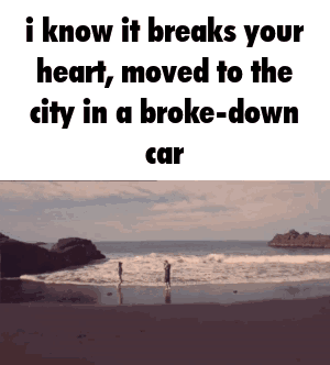 A Couple Standing On A Beach With The Words I Know It Breaks Your Heart Moved To The City In A Broke Down Car GIF