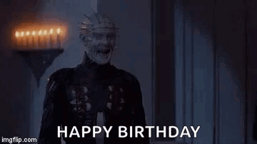 a creepy man is screaming and saying `` happy birthday '' in a room with candles .