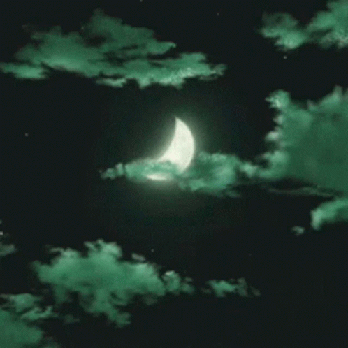 A Crescent Moon Is Visible Through The Green Clouds In The Night Sky GIF