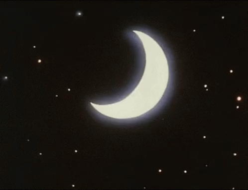A Crescent Moon With A Blue Beam Coming Out Of It In The Night Sky GIF
