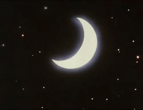 A Crescent Moon With A Blue Light Coming Out Of It In The Night Sky GIF