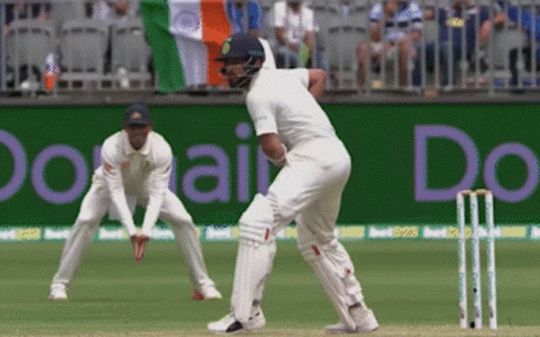A Cricket Game Is Being Played In Front Of A Banner That Says " Do " GIF
