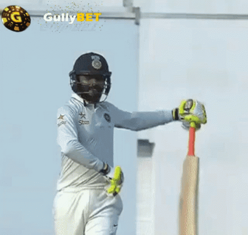 A Cricket Player Is Holding A Bat In Front Of A Gully Bet Logo GIF