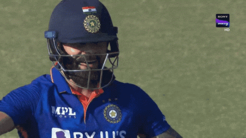 A Cricket Player Wearing A Helmet And A Blue Shirt That Says Byju 'S India GIF
