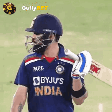 A Cricket Player Wearing A Helmet And Holding A Bat With The Word India On His Jersey GIF