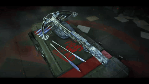 A Crossbow Is Sitting On Top Of A Box That Says " Fight The Dead " GIF