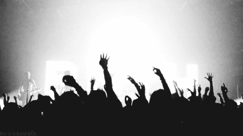 A Crowd At A Concert With Their Hands In The Air And The Words " This Is A Band-Killig " In The Background GIF