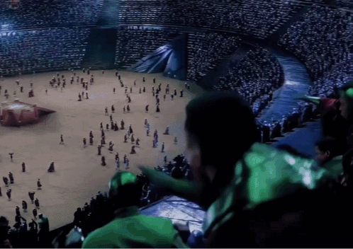 A Crowd Of People Are Gathered In A Stadium Watching A Performance GIF