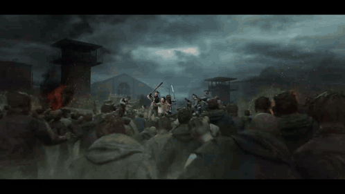 A Crowd Of People Are Gathered In Front Of A Building With A Fire In The Background GIF