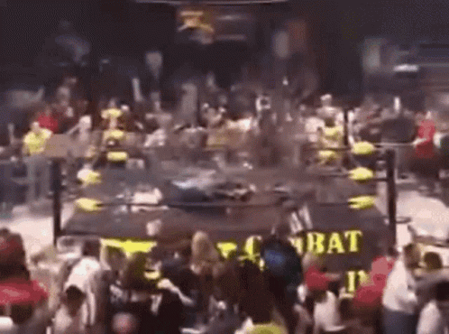 A Crowd Of People Are Gathered In Front Of A Sign That Says Combat . GIF