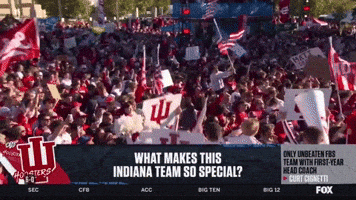 A Crowd Of People Are Gathered In Front Of A Sign That Says Indiana GIF