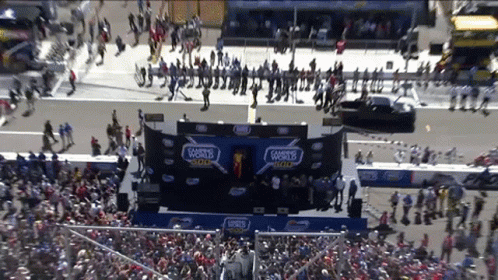 A Crowd Of People Are Gathered In Front Of A Stage That Says 500 On It GIF