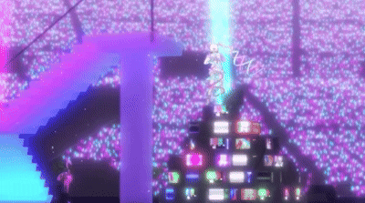 A Crowd Of People Are Watching A Concert In A Stadium Filled With Lots Of Lights . GIF